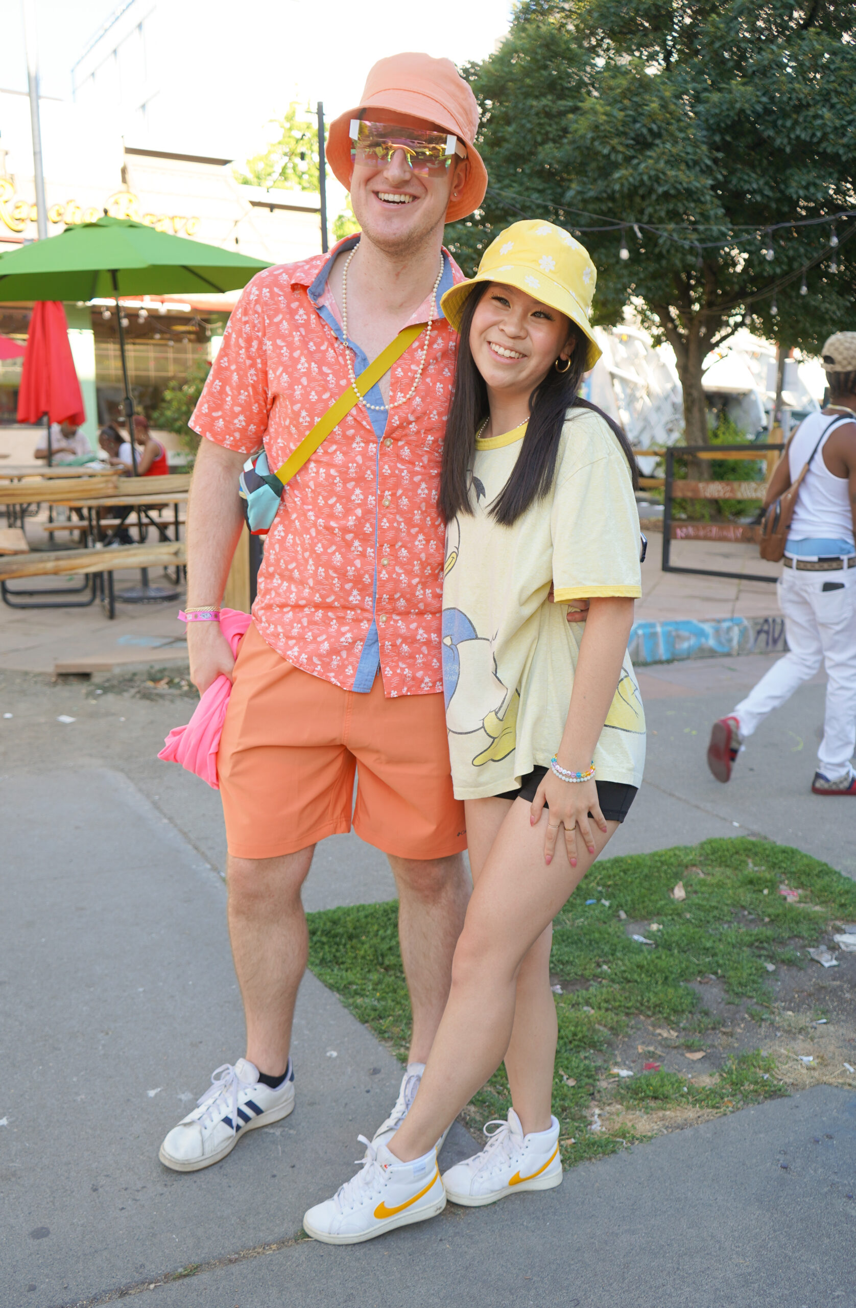 Blake confidently embraces orange hues from head to toe, while  Jojo Yen (right) went with an
all-yellow ensemble featuring a Donald Duck tee topped with a reversible yellow bucket hat.